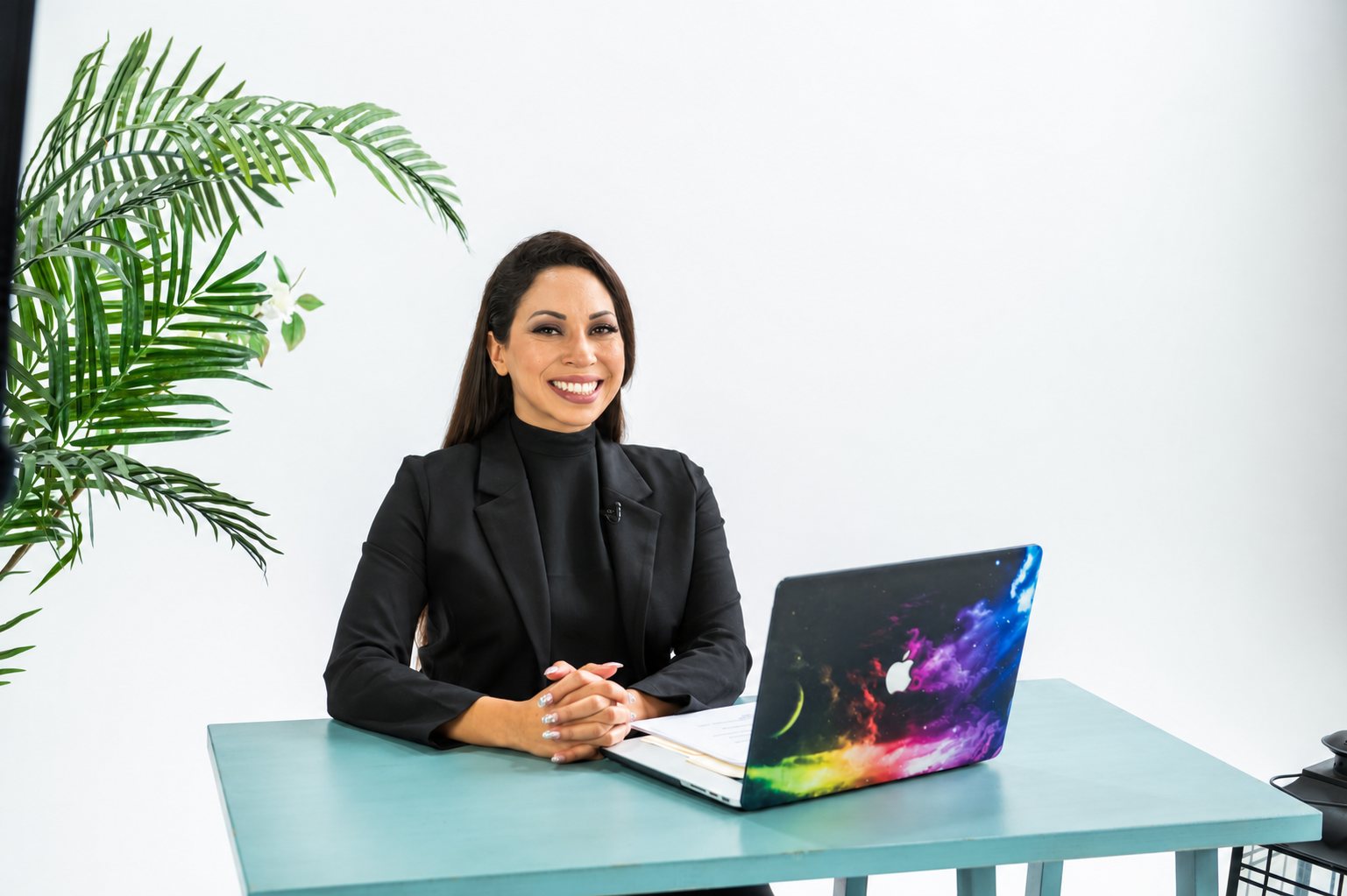 Sabrina Brooks, founder of Vantalyst, seated at her desk with a laptop.